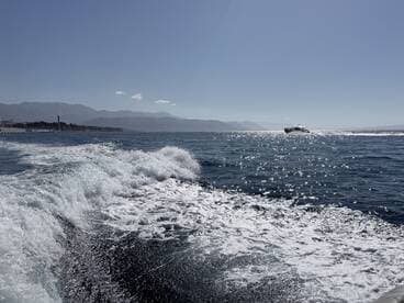 A stunning view of a yacht cruising through sparkling ocean waters, showcasing the beauty of a day on the sea.