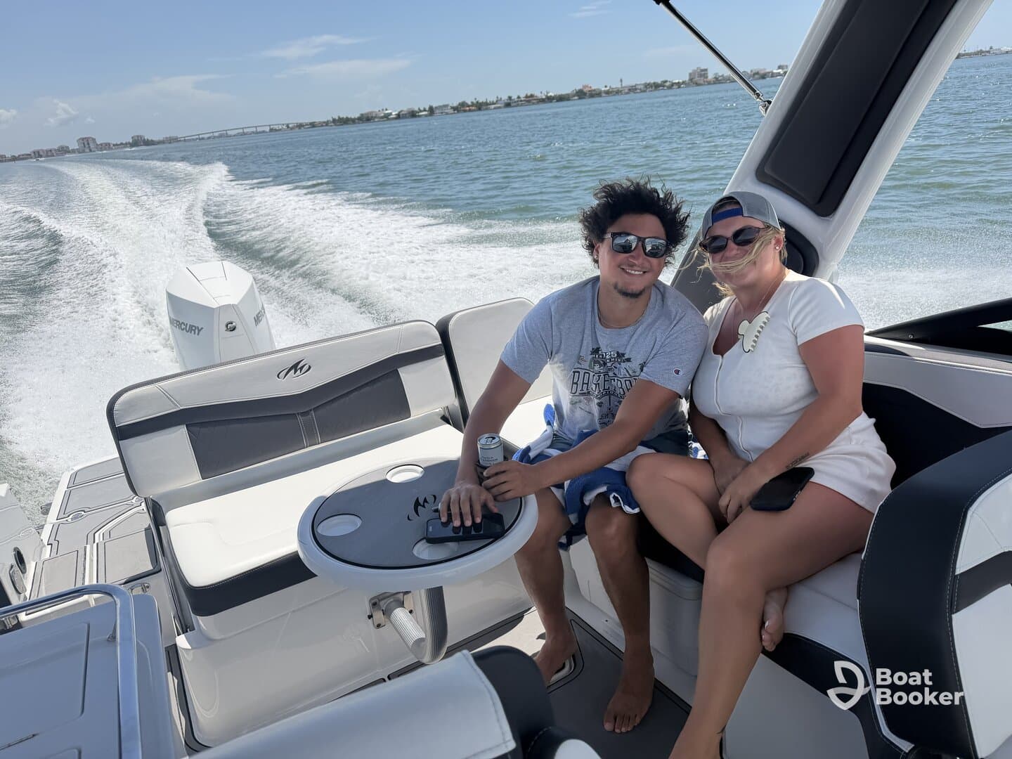 A couple enjoys a sunny day on a boat, capturing the essence of fun and relaxation on the water.
