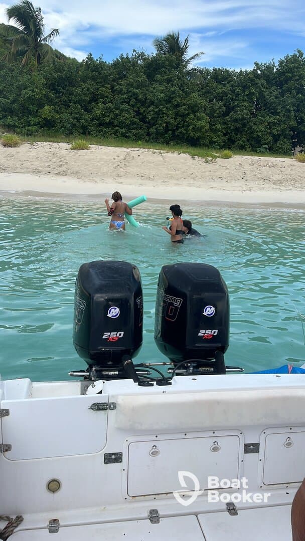 Children enjoy a fun day swimming in shallow waters, playing with pool noodles near a sandy beach — a perfect family-friendly beach outing.