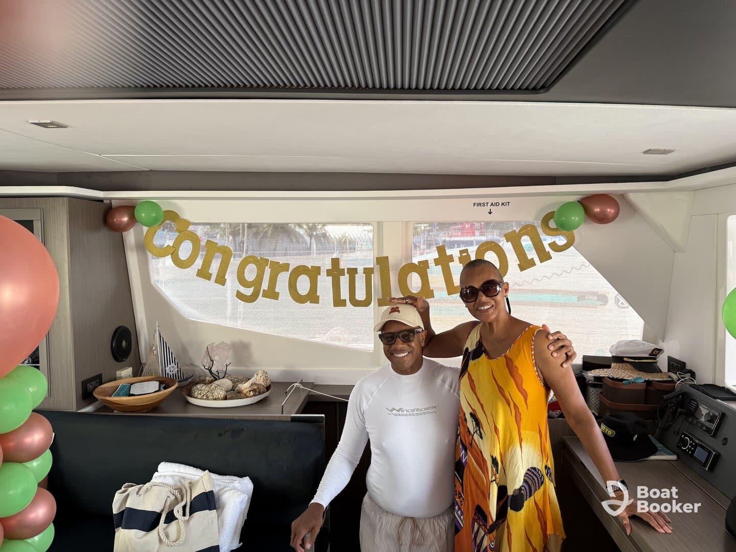 A joyful celebration aboard a boat, featuring a 'Congratulations' banner and two guests enjoying the festive atmosphere — perfect for special occasions on the water.