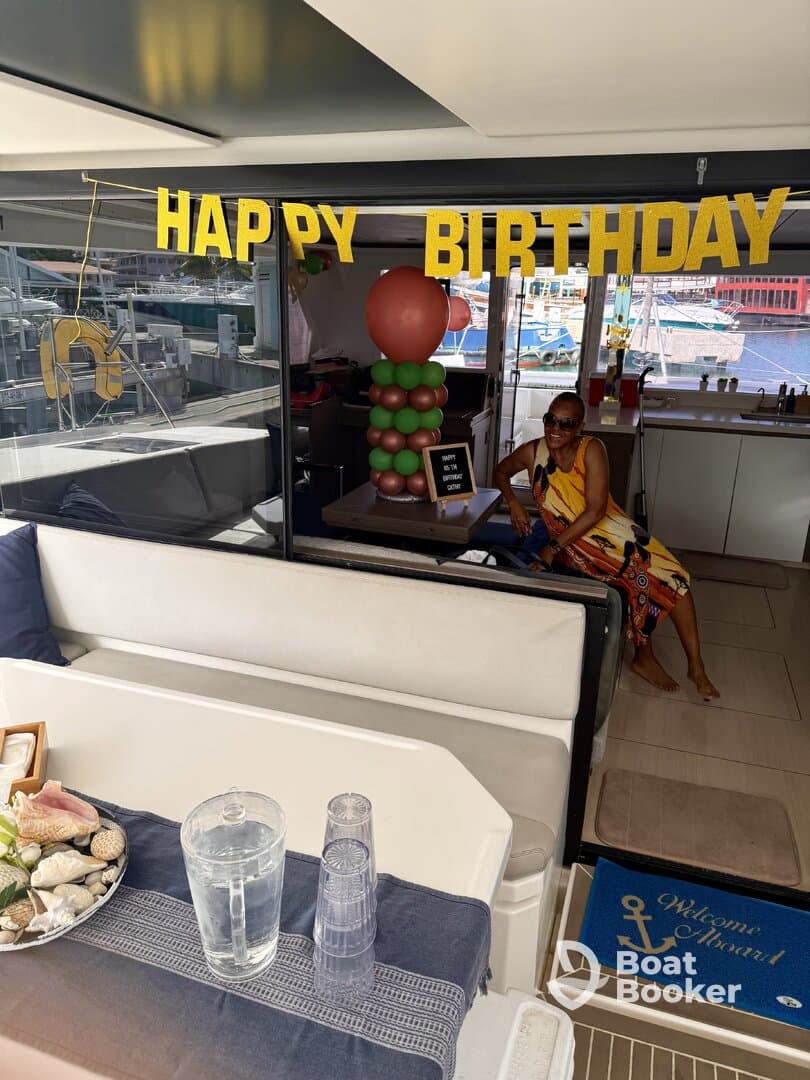 A festive birthday celebration inside a boat cabin, featuring decorations and a guest enjoying the ambiance. Perfect for intimate gatherings on the water.