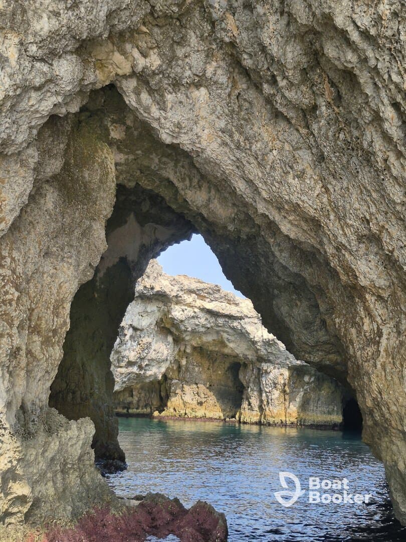 A stunning view of natural rock formations and a serene waterway, perfect for exploring coastal caves and enjoying the beauty of nature.