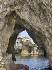 A stunning view of natural rock formations and a serene waterway, perfect for exploring coastal caves and enjoying the beauty of nature.