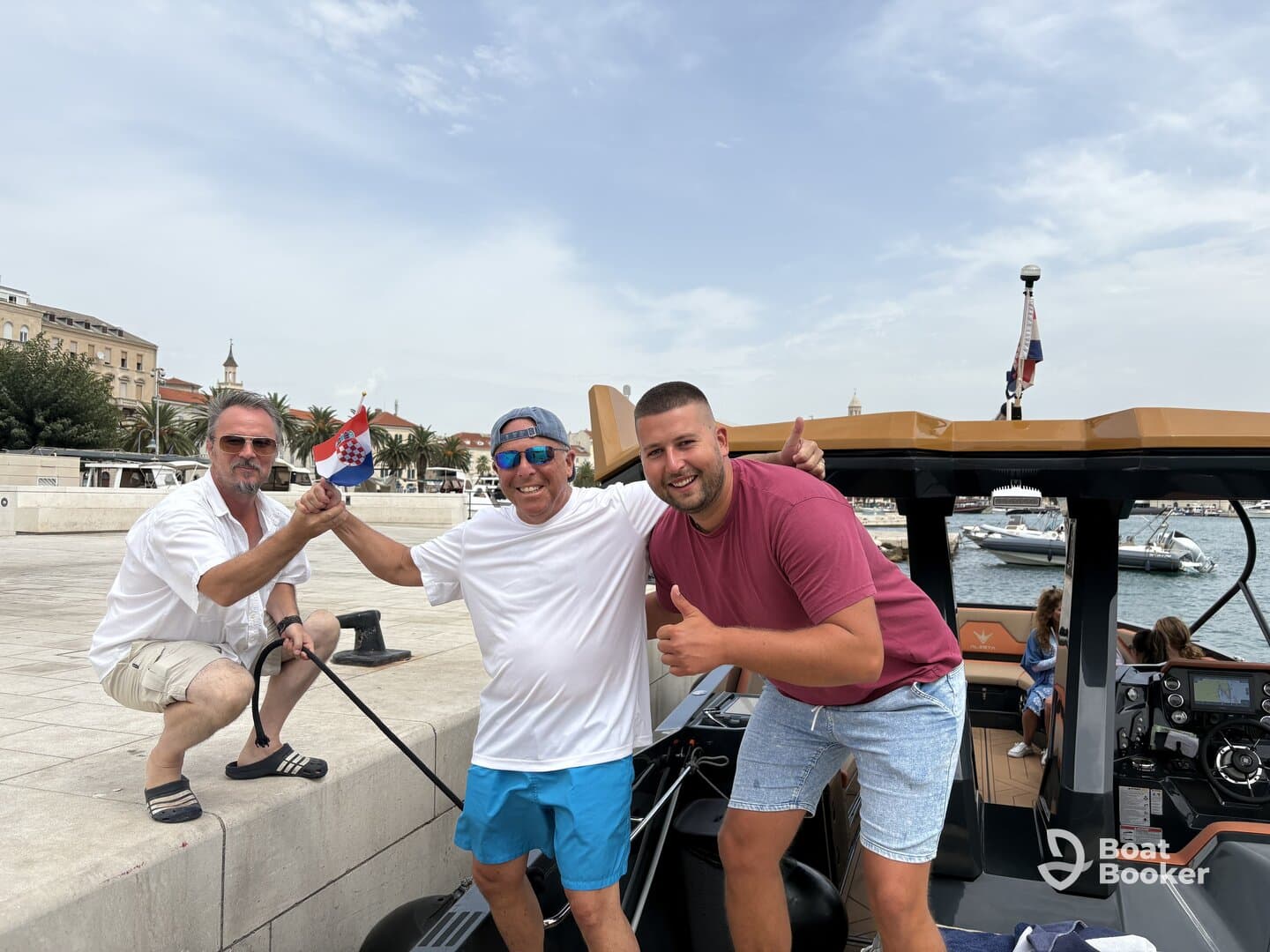 A cheerful group of friends celebrates by a boat in a vibrant marina, showcasing the joy of boating adventures together.