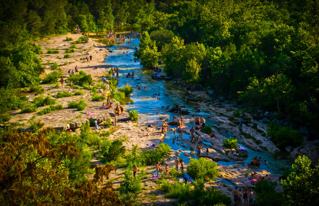 Austin Texas: Summer Crowds Enjoying The Barton Springs, an ideal choice for kid-friendly outdoor activites in Austin